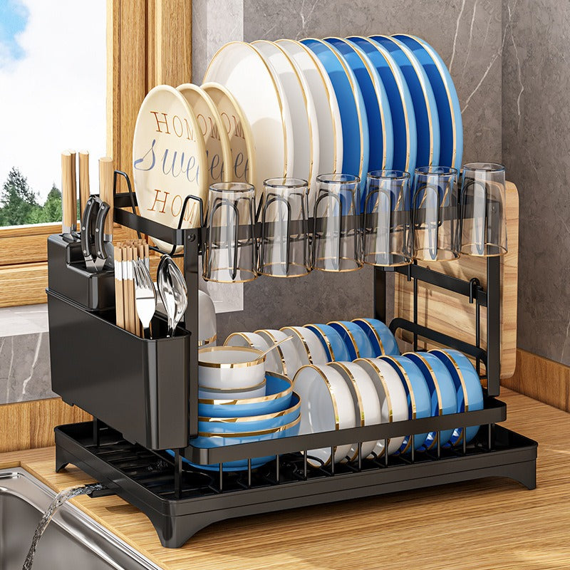 Kitchen drainage rack with bowls, plates, and utensils drying on a countertop