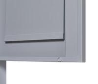 Grey metal kitchen storage cabinet with door and adjustable shelf in a modern kitchen