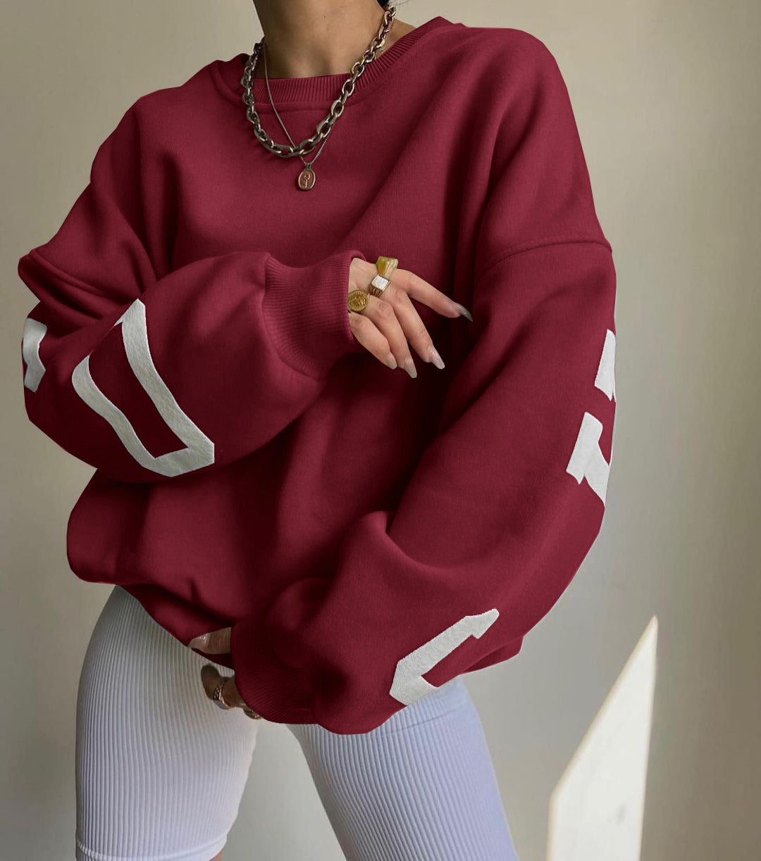 Woman wearing a printed thick long sleeve hoodie, looking cozy and stylish.

