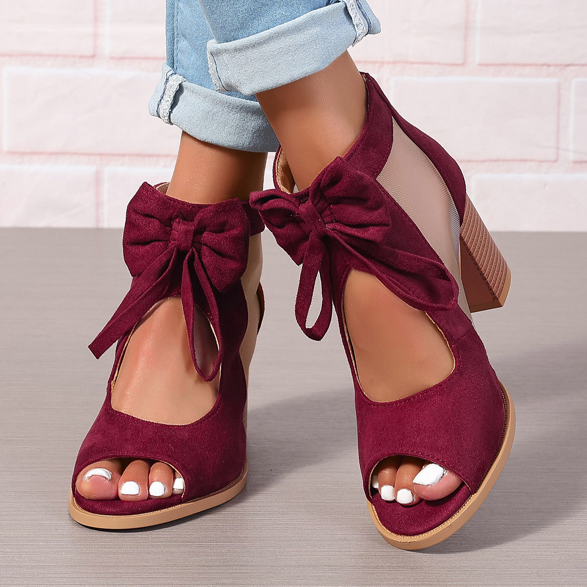 Women's platform chunky high heel sandals with bow decoration and ankle strap.

