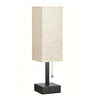 Modern square linen desk lamp with USB charging ports and 3-color dimmable lighting on a minimalist nightstand

