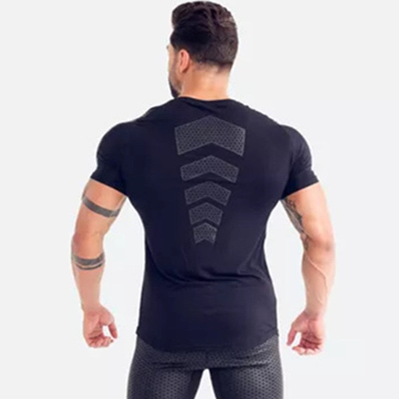 Man wearing a tight-fit short sleeve compression T-shirt in quick-dry fabric for running and sports training.

