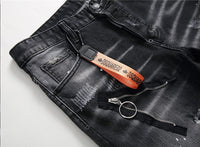 Men’s black and gray distressed jeans with torn holes and zipper decoration.

