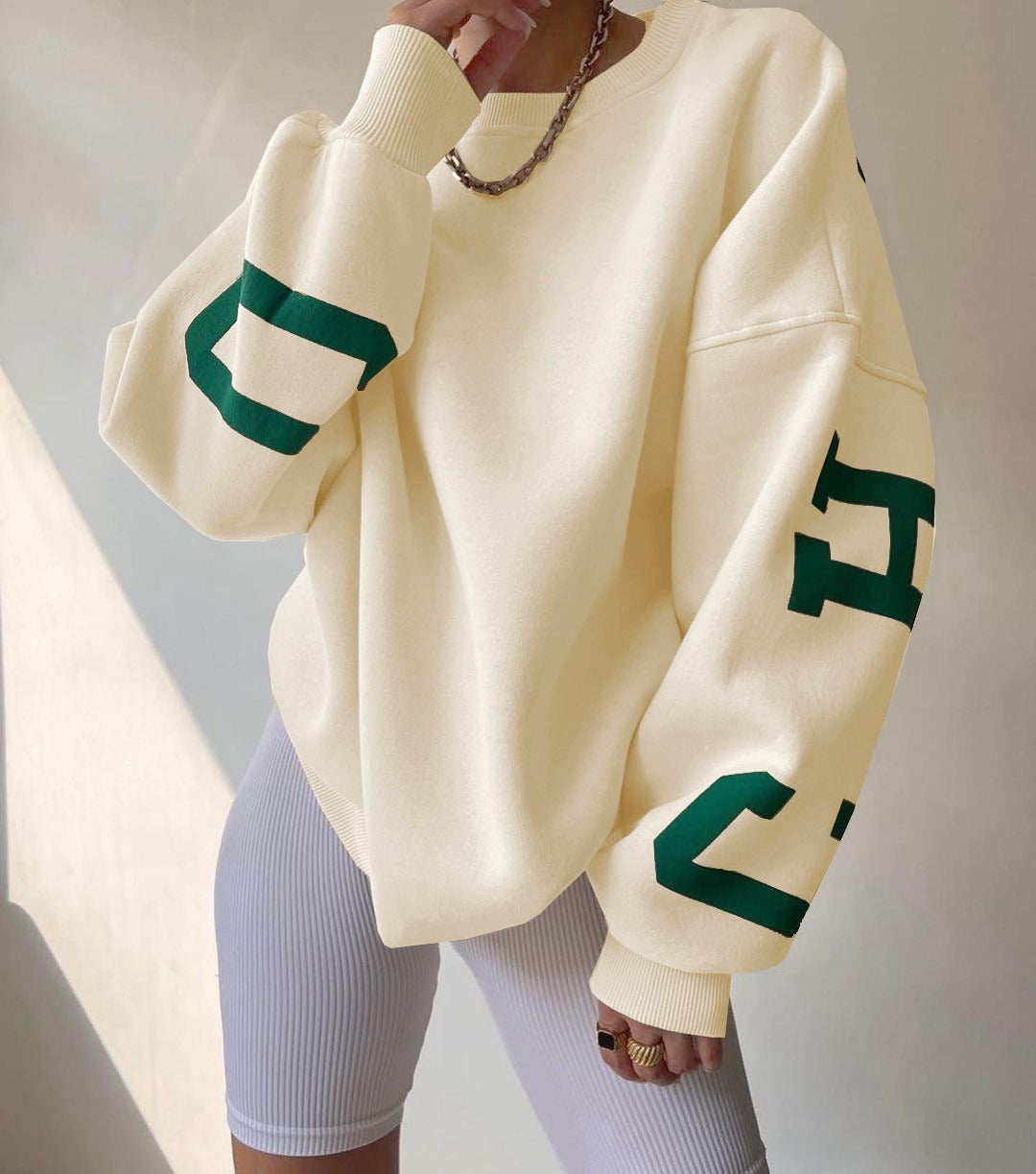 Woman wearing a printed thick long sleeve hoodie, looking cozy and stylish.

