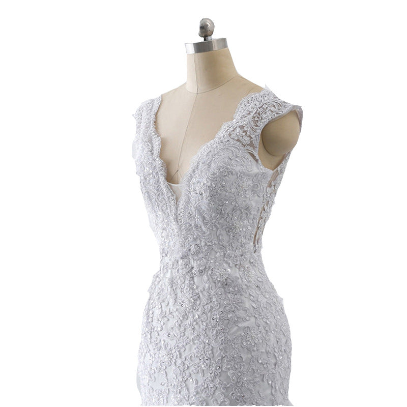 A luxurious mermaid wedding dress with a light trailing train, French retro design, and delicate lace details, perfect for an elegant and slim bridal look.

