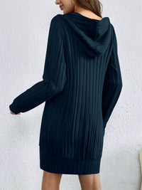 Navy blue oversized hoodie worn by a person against a white background