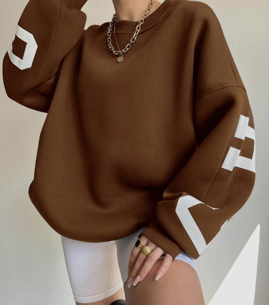 Woman wearing a printed thick long sleeve hoodie, looking cozy and stylish.

