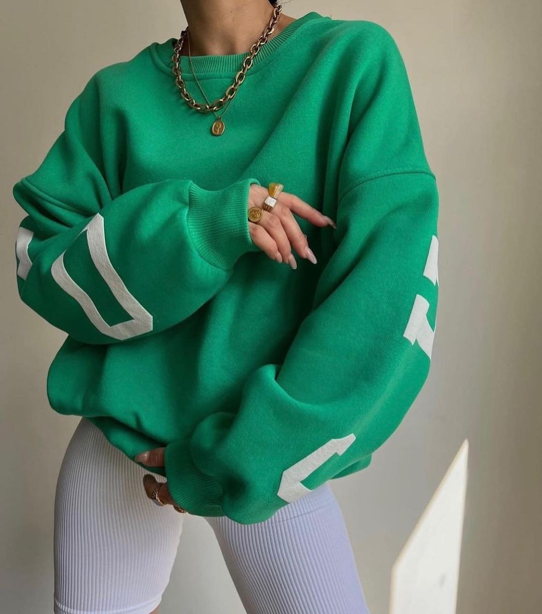 Woman wearing a printed thick long sleeve hoodie, looking cozy and stylish.

