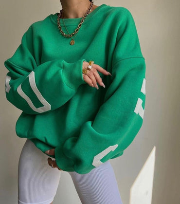 Woman wearing a printed thick long sleeve hoodie, looking cozy and stylish.

