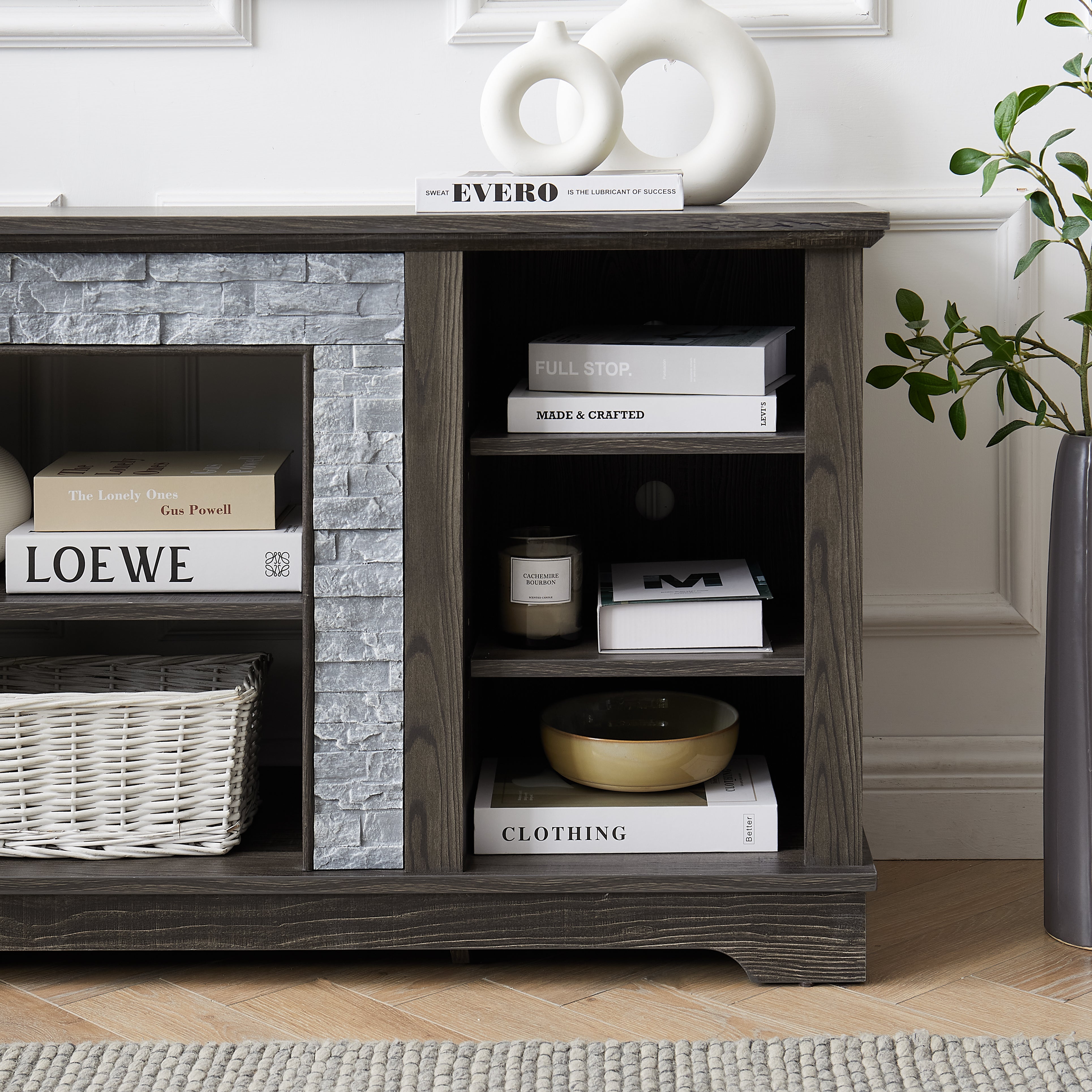 Modern gray stone TV console with open shelves and stacked stone frame