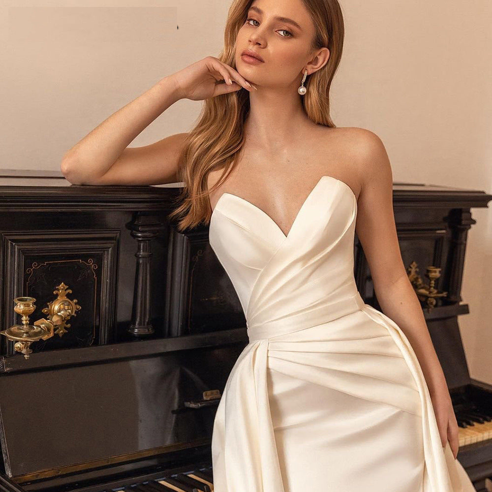Elegant satin sheath wedding dress with a backless design, high waist fit, and a two-way detachable train for a customizable bridal look.

