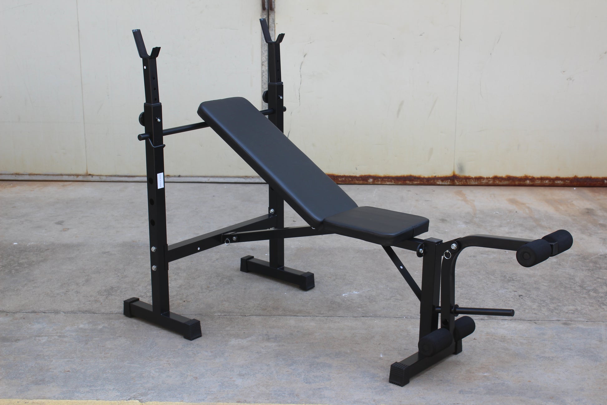 Olympic weight bench with adjustable squat rack, designed for strength training, featuring sturdy construction and multiple settings for bench press, squats, and other weightlifting exercises.