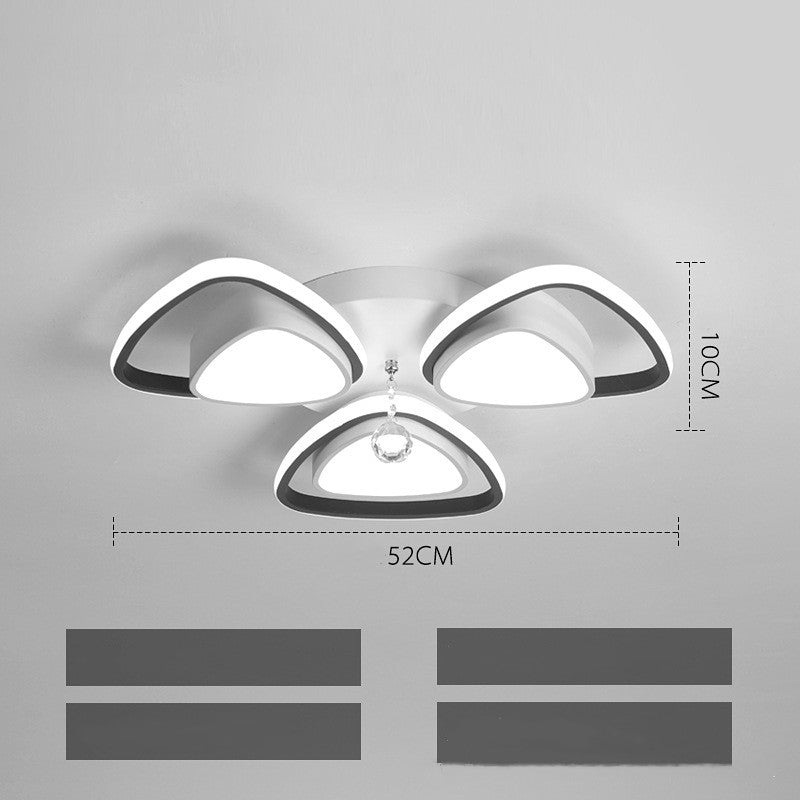 High-end modern ceiling light illuminating a cozy bedroom with elegant decor

