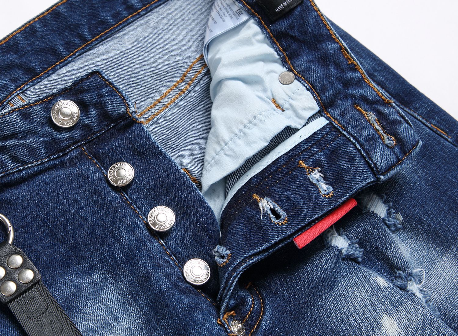 Men’s ripped fashion jeans with ornamental details, slim fit, and distressed design for a trendy streetwear look.