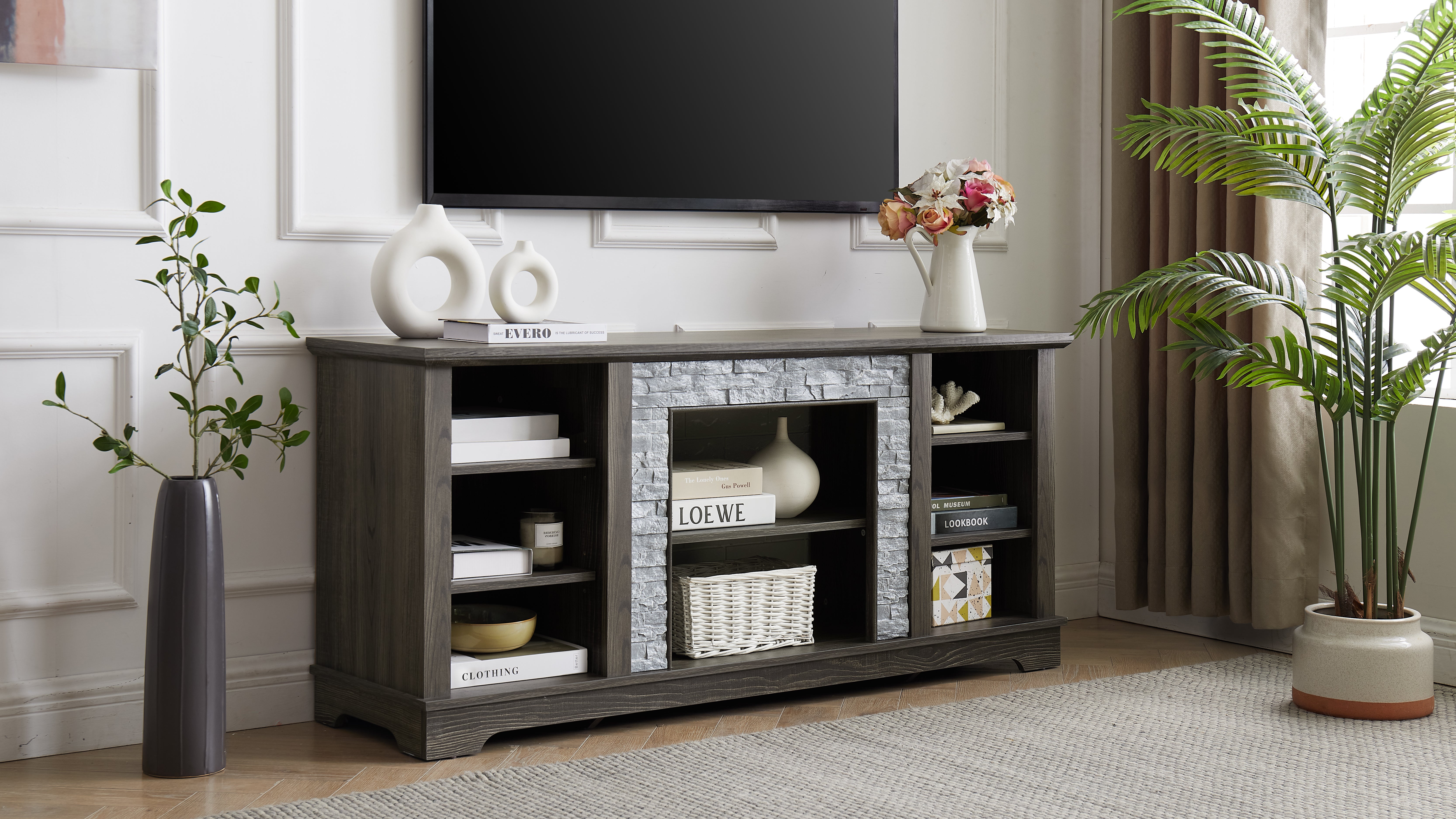 Modern gray stone TV console with open shelves and stacked stone frame