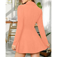 A woman wearing a peach-colored long-sleeve mini dress, shown from the back in a bright indoor room setting.