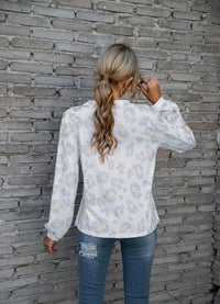 Women's long-sleeve V-neck top with a bold leopard print pattern, perfect for adding a touch of fierce fashion to your wardrobe.








