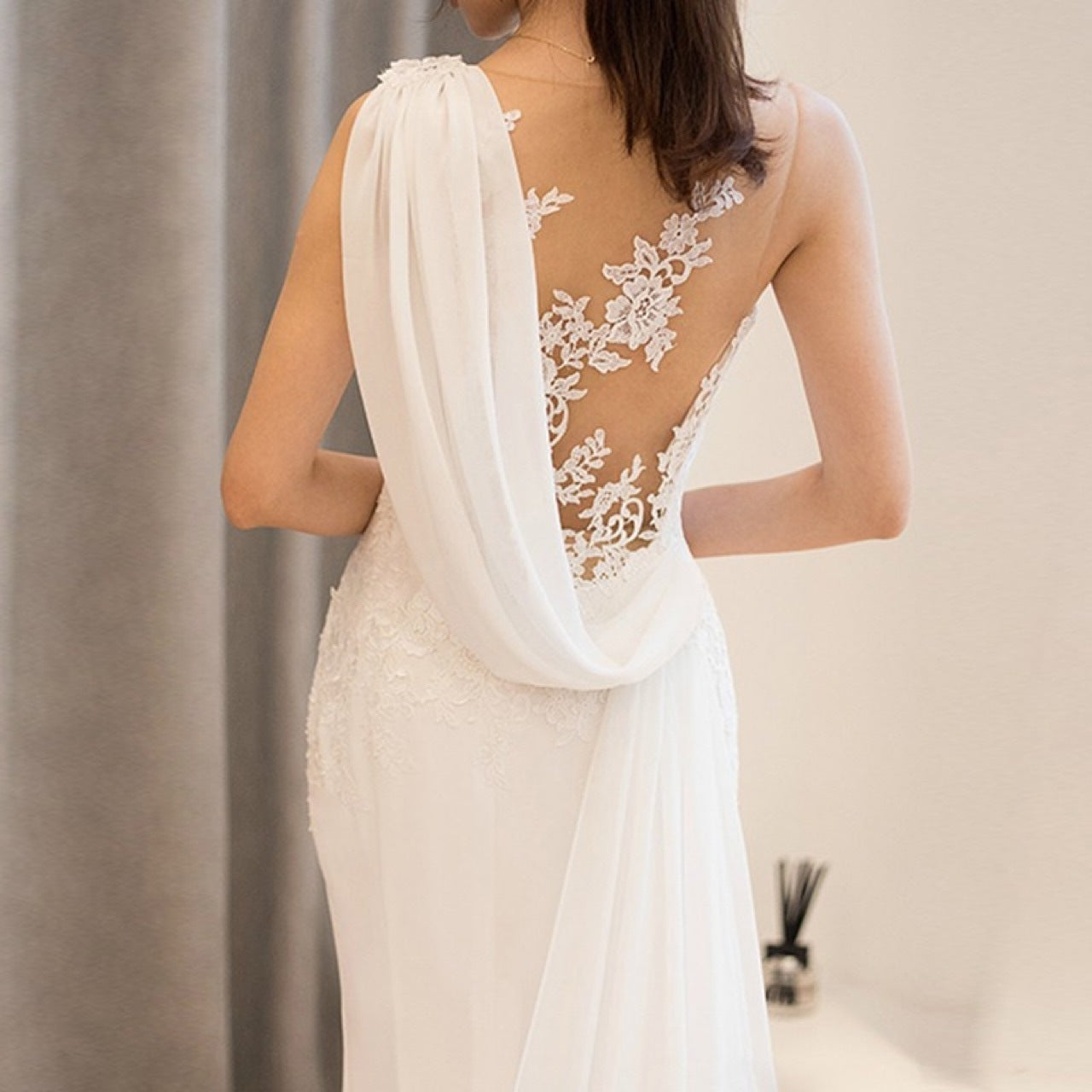 Elegant mid-waist see-through light wedding dress with a dreamy, fairy-like design, featuring delicate lace and a soft flowing silhouette.

