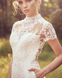 Modern bride pants suit featuring a short sleeve wedding jumpsuit, tailored for elegance and a sophisticated bridal look.


