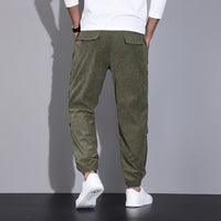Men's corduroy overalls with ankle-tied loose fit and multi-pocket design for casual wear.