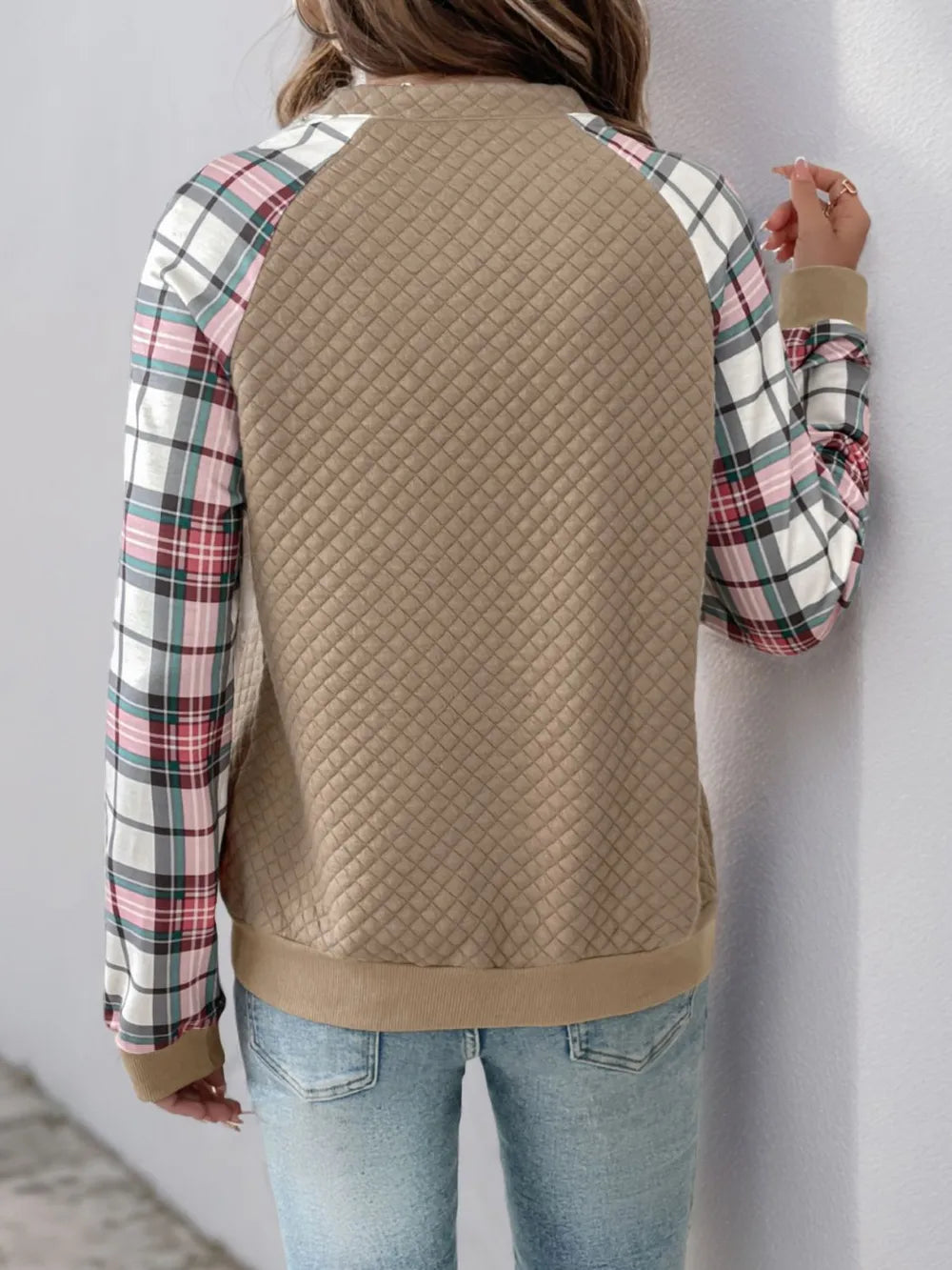 Front view of women’s plaid half zip sweatshirt with long sleeves and textured fabric

