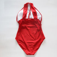 Tequila Shots cross halter swimsuit featuring a trendy and bold design with a flattering cross-back halter top. Made from high-quality, stretchy fabric for comfort and style, perfect for beach days, pool parties, and sunny vacations.