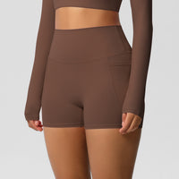 Brown athletic outfit with long-sleeve top and shorts on a plain background