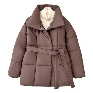 Model wearing a short tie-waist puffer jacket with a stand collar and boots