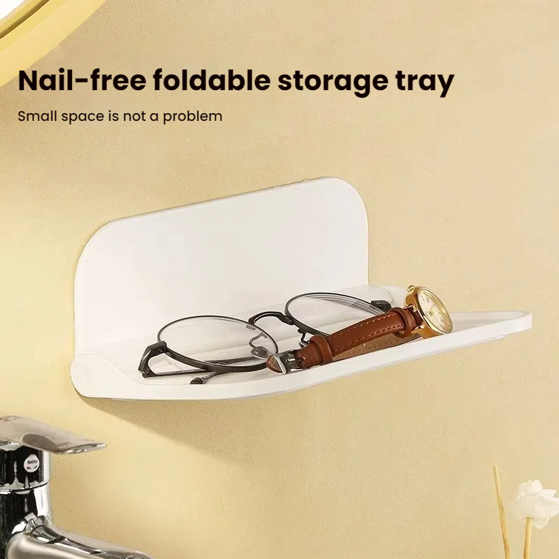Wall-mounted plastic floating shelf in a modern bathroom holding towels