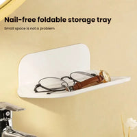 Wall-mounted plastic floating shelf in a modern bathroom holding towels