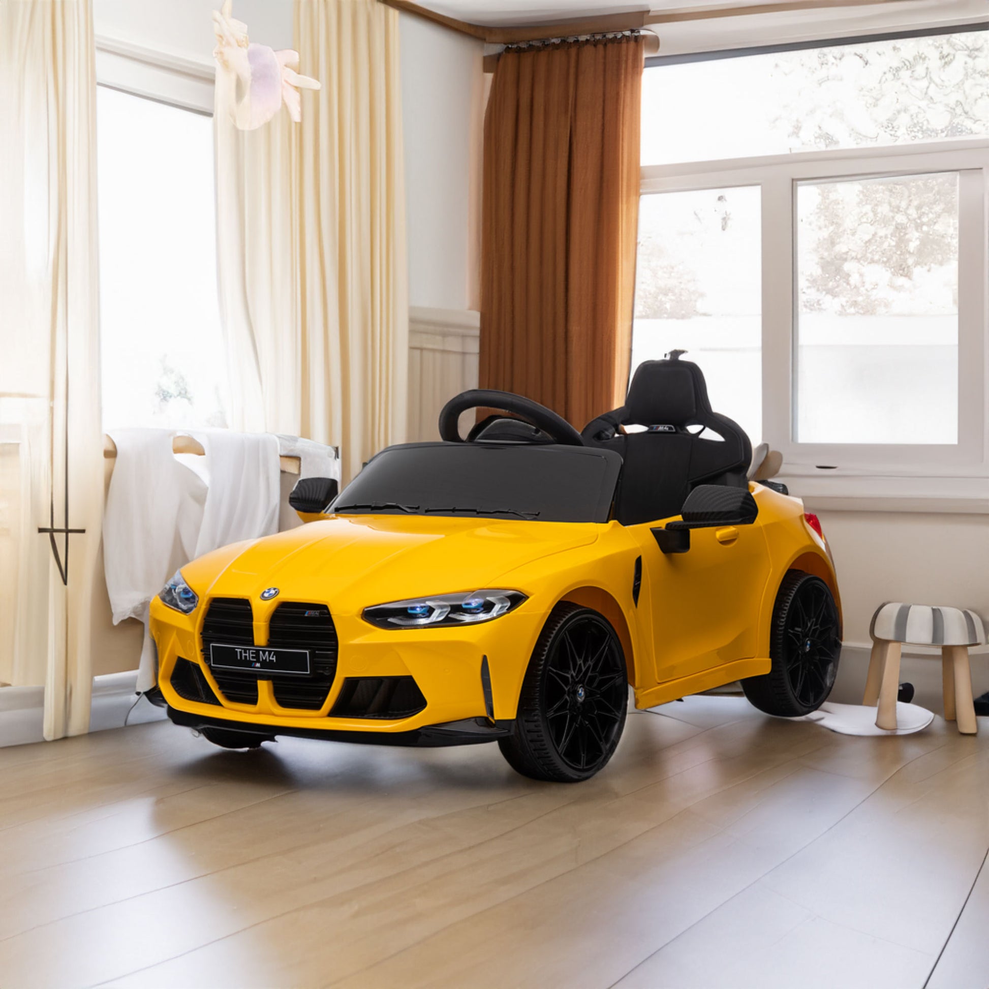 Yellow BMW M4 12V electric ride-on car for kids, featuring authentic design with working headlights, MP3 player, and forward/reverse motion. Comes with adjustable seat and steering wheel, providing a realistic driving experience for children aged 3-6