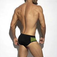Men’s close-fitting swim briefs with polka dot stitching, designed for beach and sports activities.

