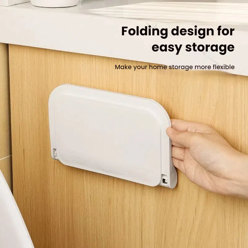 Wall-mounted plastic floating shelf in a modern bathroom holding towels