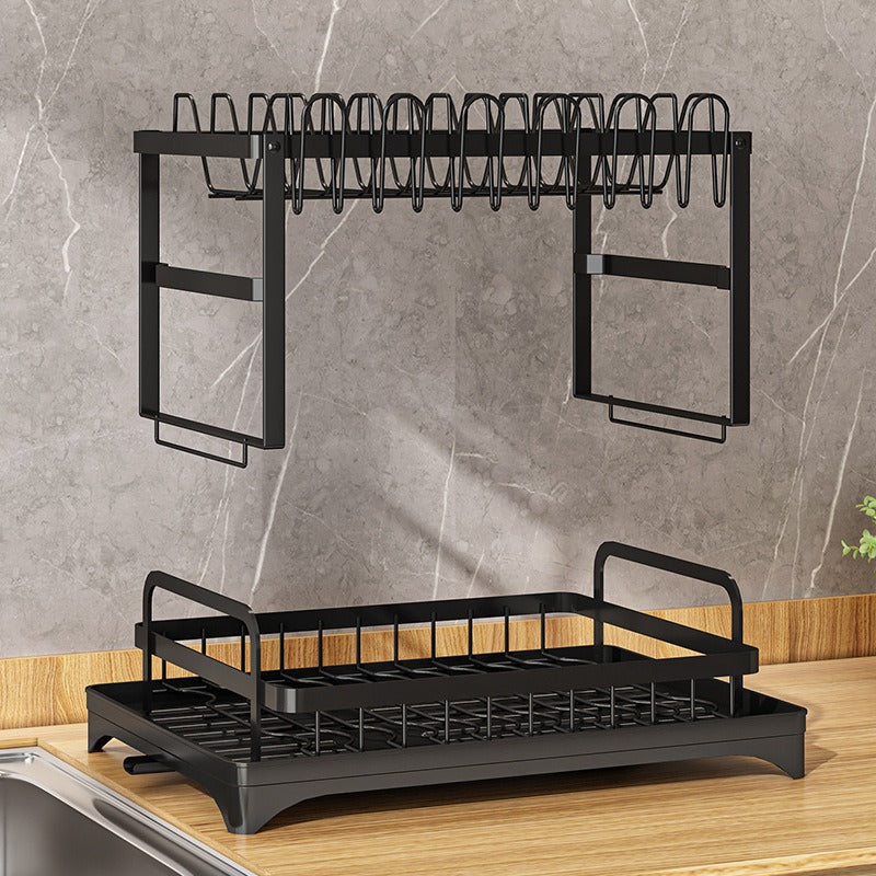 Kitchen drainage rack with bowls, plates, and utensils drying on a countertop

