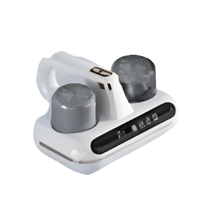 Cordless handheld mattress vacuum being used on a white bed