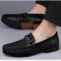 Men’s slip-on driving shoes in snake-pattern embossed leather with flat sole design.

