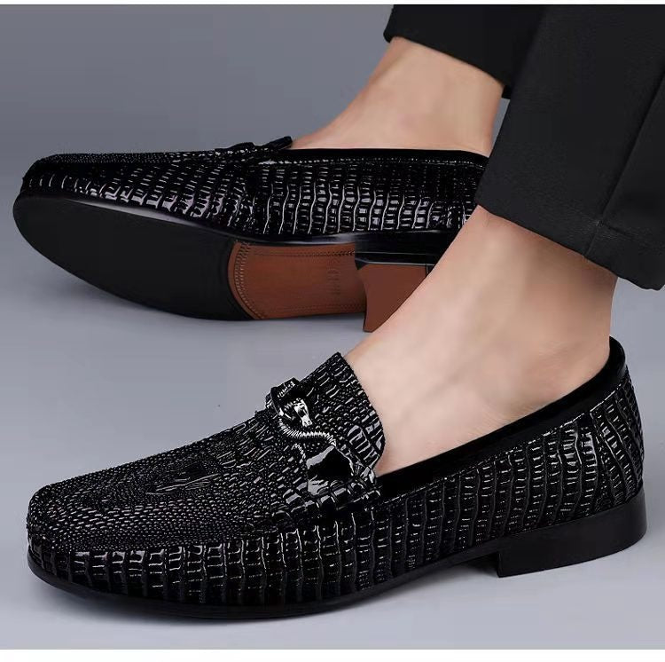 Men’s slip-on driving shoes in snake-pattern embossed leather with flat sole design.

