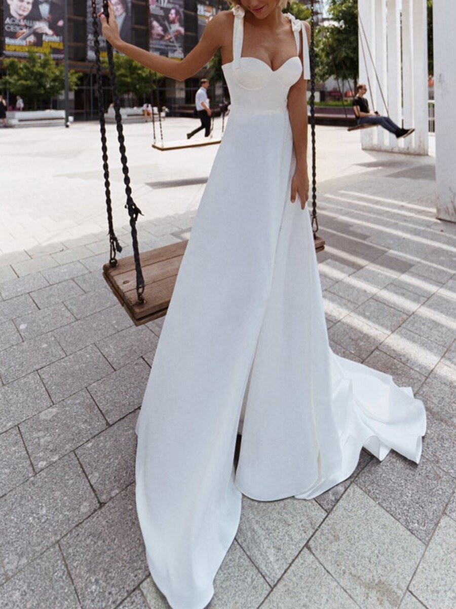 A stylish sexy sling wedding dress featuring a sleek silhouette, delicate straps, and a flowy design, perfect for modern brides.

