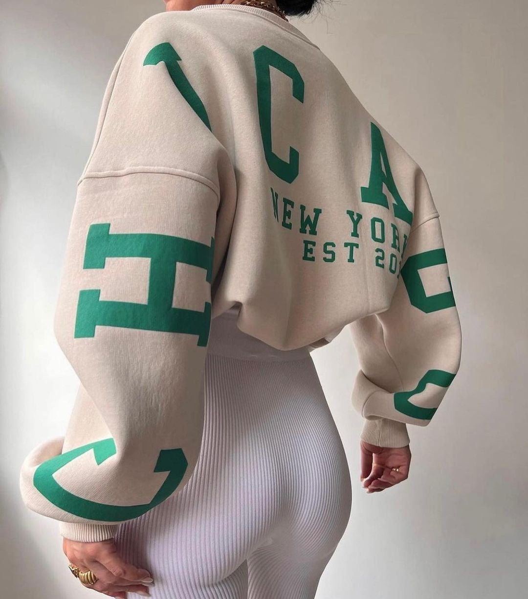 Woman wearing a printed thick long sleeve hoodie, looking cozy and stylish.

