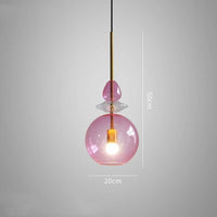 Colorful macaron-style glass chandeliers hanging over a modern bar counter

