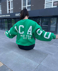 Woman wearing a printed thick long sleeve hoodie, looking cozy and stylish.

