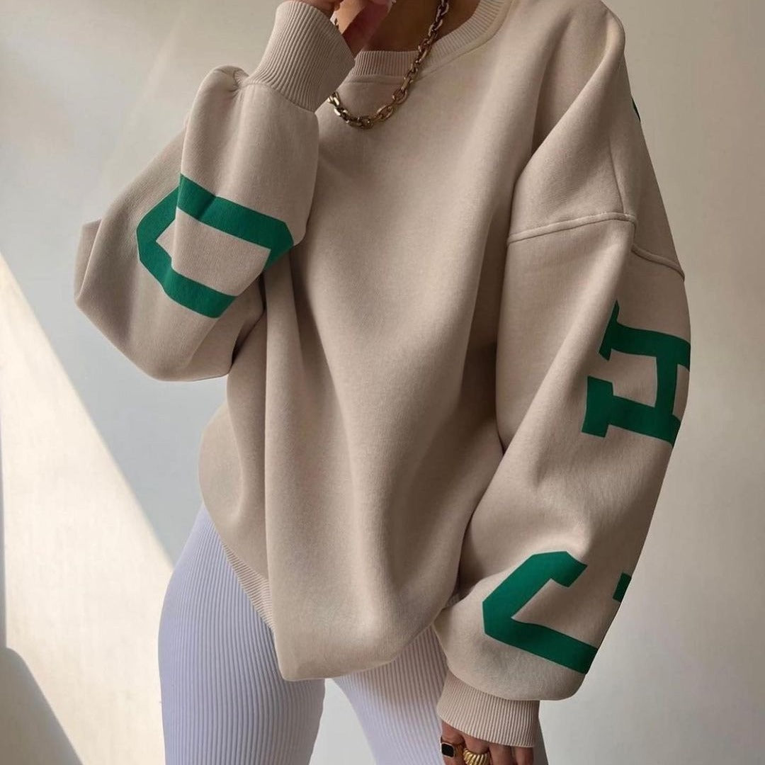 Woman wearing a printed thick long sleeve hoodie, looking cozy and stylish.

