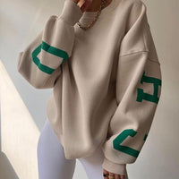 Woman wearing a printed thick long sleeve hoodie, looking cozy and stylish.

