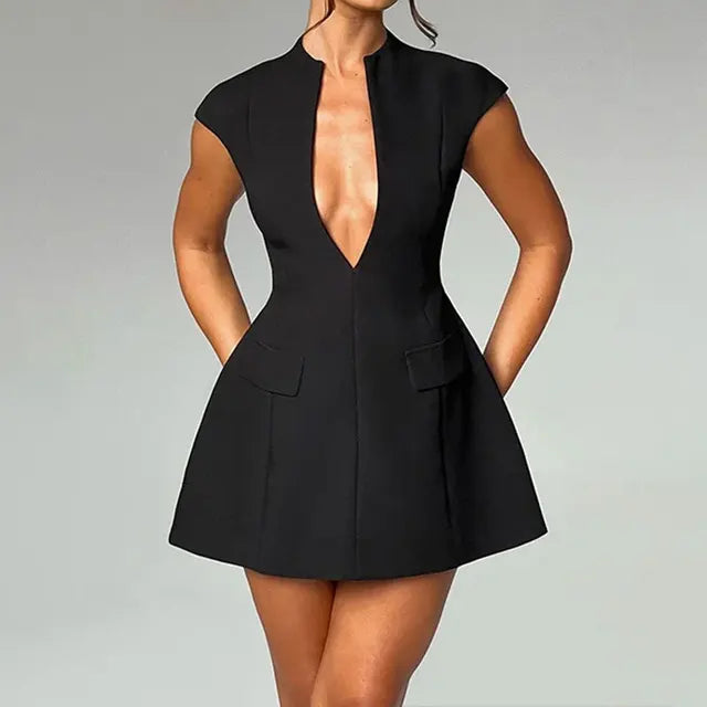Woman wearing a black sleeveless A-line mini dress with deep V-neck and pockets.

