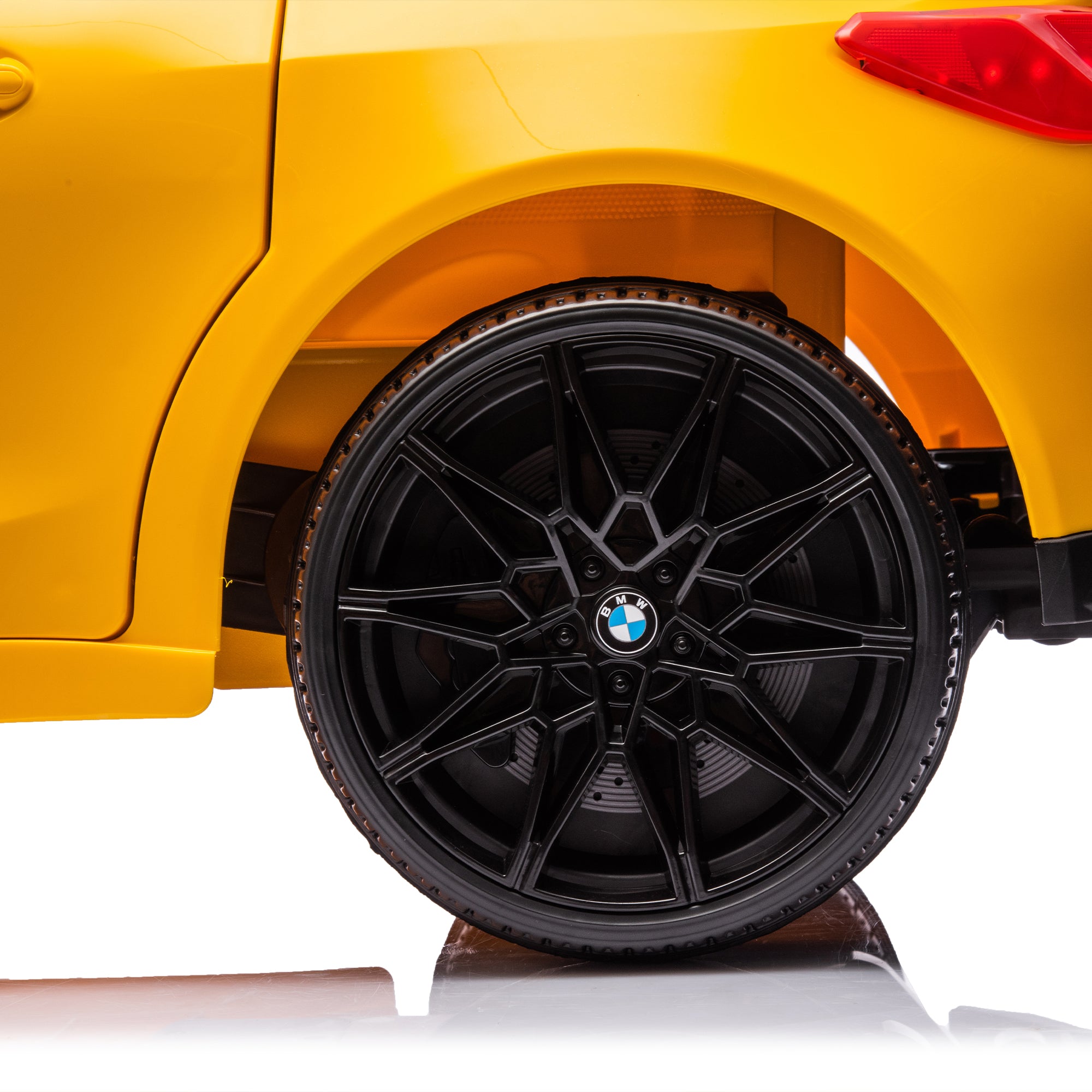 Yellow BMW M4 12V electric ride-on car for kids, featuring authentic design with working headlights, MP3 player, and forward/reverse motion. Comes with adjustable seat and steering wheel, providing a realistic driving experience for children aged 3-6