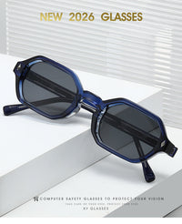Blue translucent computer safety glasses with dark lenses, displayed on a white geometric platform with promotional text overlays.