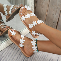 Flat Roman sandals with a flower design, offering comfort and style for summer outfits.








