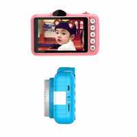 A children's instant camera shown from two angles on a white background: a back view with a pink back and a color screen displaying a child's photo, and a side view showing a blue body with a white front panel.