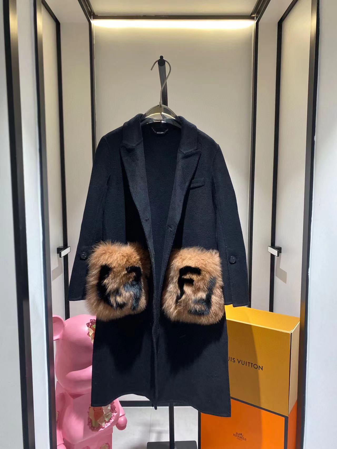 Woman wearing a solid minimalist woolen coat with a cozy scarf and boots