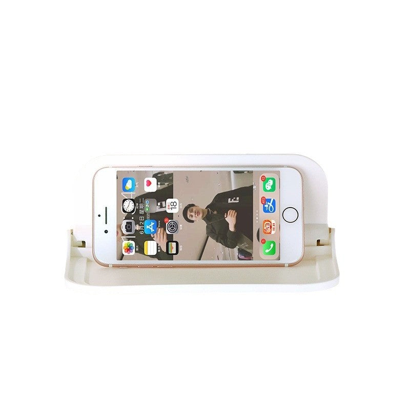 Wall-mounted plastic floating shelf in a modern bathroom holding towels